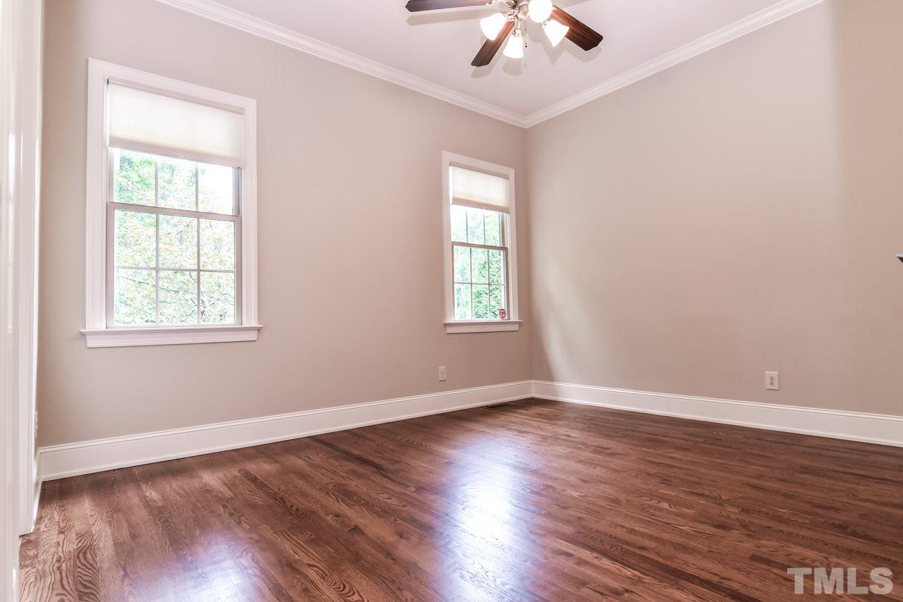 6924 Mactavish Way Raleigh, NC 27613 - Photo 12 of 30 Guest bedroom located off the keeping room/library on the main level. Has an attached full bath and walk in closet.