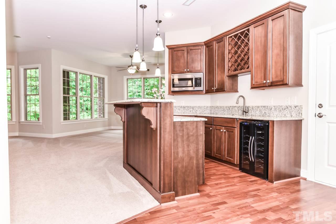 6924 Mactavish Way Raleigh, NC 27613 - Photo 19 of 30 Daylight basement with separate entrances inside and outside, makes for easy multigenerational living! The basement includes a kitchenette, a flex room that could be used as a bedroom, a full bath, and lots of living space.