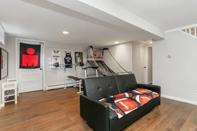 a living room with furniture and wooden floor