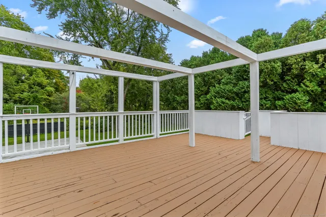 a view of balcony with wooden floor and fence