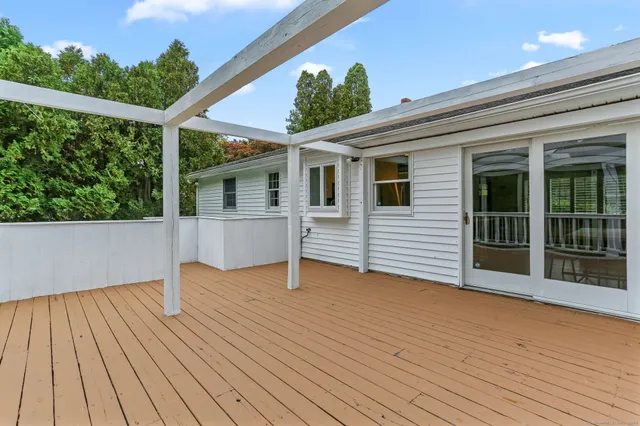 a view of backyard with deck and wooden floor