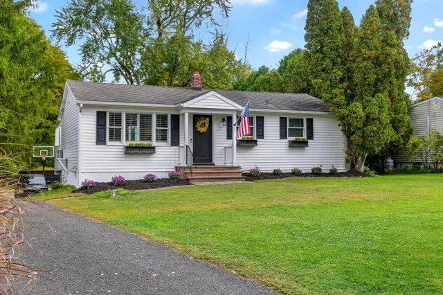 a front view of house with yard and seating area