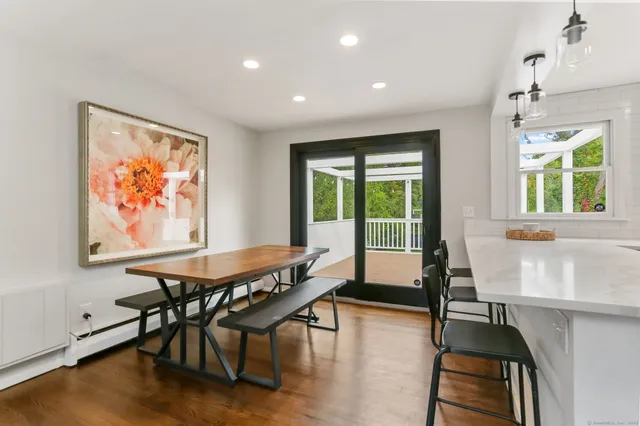 a living room with furniture a window and wooden floor