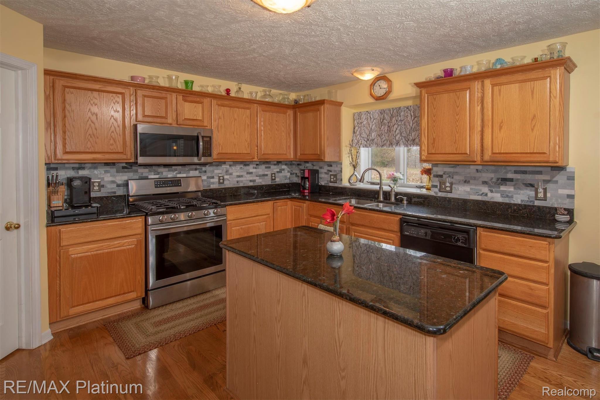 2500 Ridgewood Drive Howell, MI 48843 - Photo 10 of 31 Granite Countertops and beautiful tile backsplash