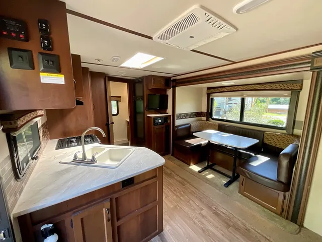 a kitchen with a sink appliances and a dining table