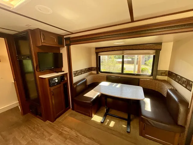 a view of a workspace with furniture and window