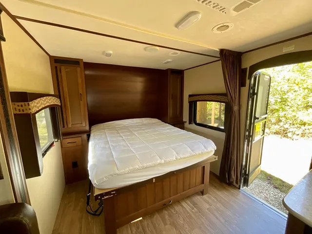 a bedroom with a bed and a mirror