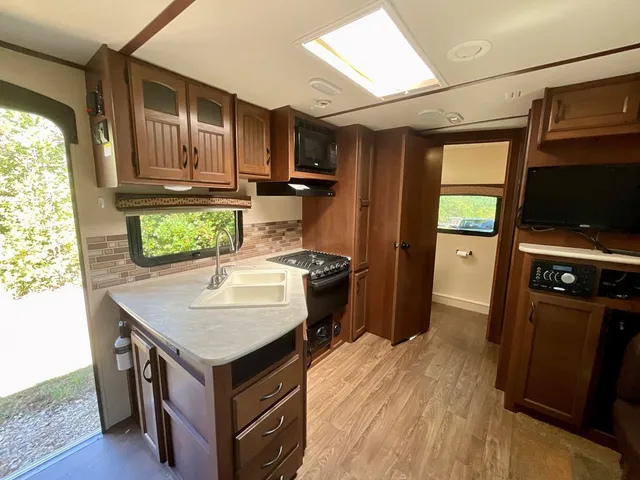 a kitchen with a stove window and refrigerator