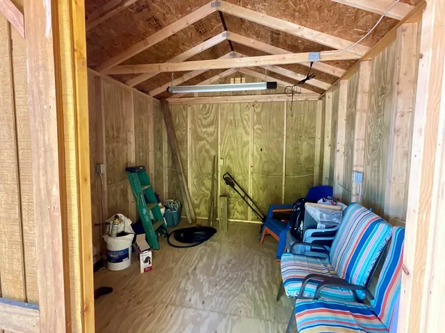 a view of a livingroom with furniture and a window