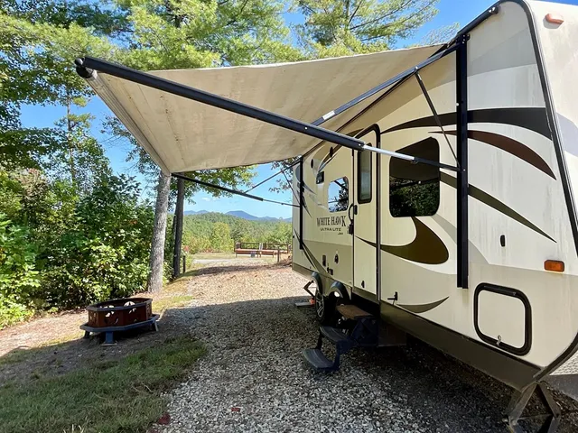 a white house with tall trees in front of it