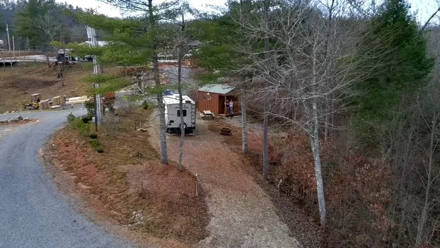a white house that has a tree in front of it