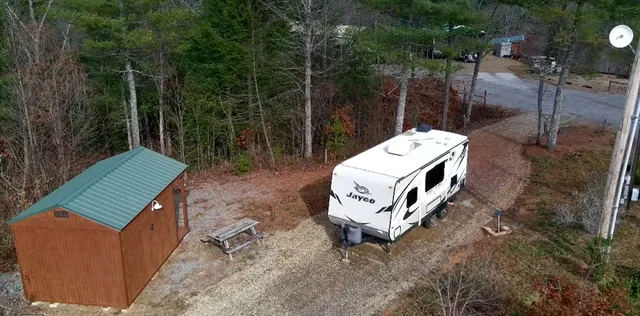 an aerial view of a house with a yard and wooden fence
