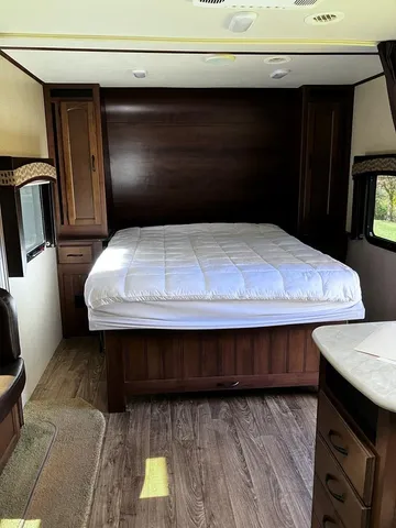 a view of kitchen with wooden floor and cabinets