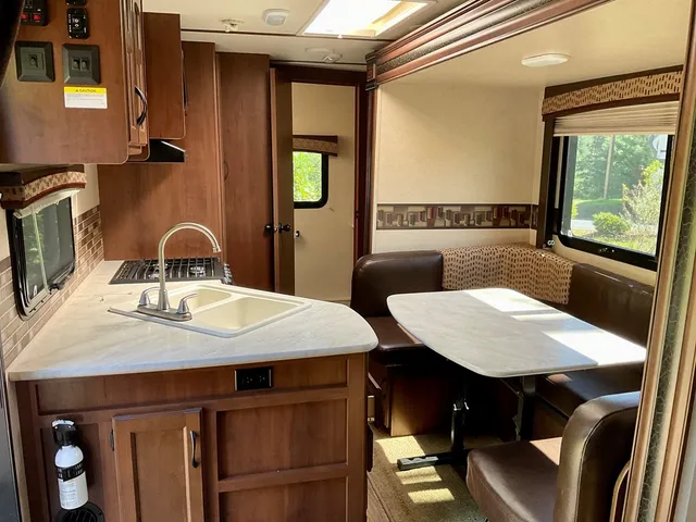 a view of a dining room with a table and chairs