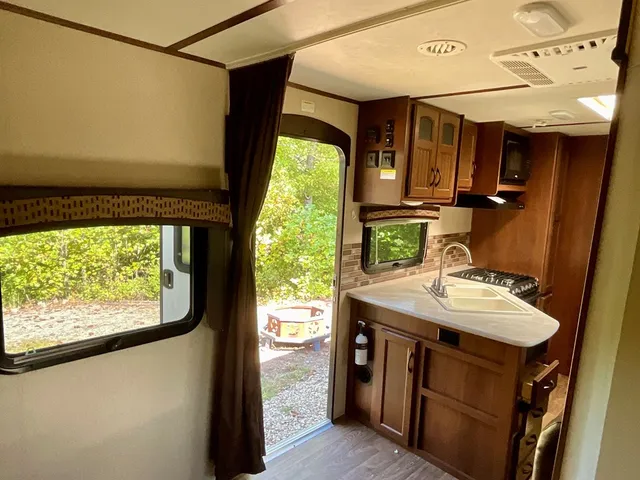 a bathroom with a sink a mirror and next to a window