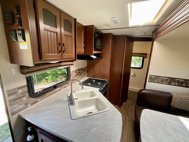 a kitchen with stainless steel appliances granite countertop a sink refrigerator and microwave