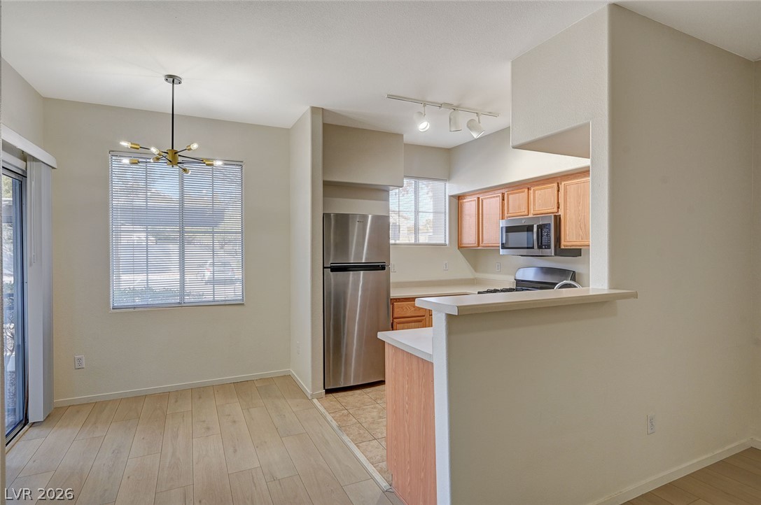 9050 West Warm Springs Road, Unit 1147 Las Vegas, NV 89148 - Photo 7 of 36 Bright, open-concept kitchen and dining area, ready for modern living.