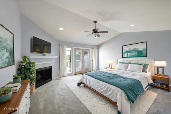a spacious bedroom with a large bed and a flat screen tv