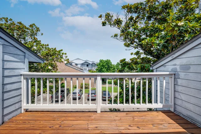 a balcony with wooden floor and outdoor space