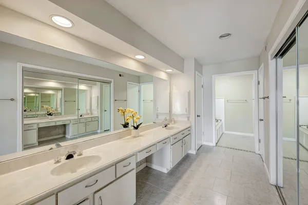 a spacious bathroom with a double vanity sink mirror and double