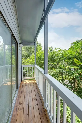 a view of a balcony with wooden floor