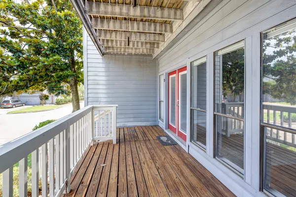 a balcony with wooden floor and outdoor space