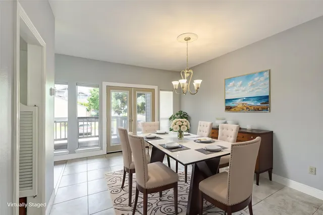 a view of a dining room with furniture wooden floor and chandelier