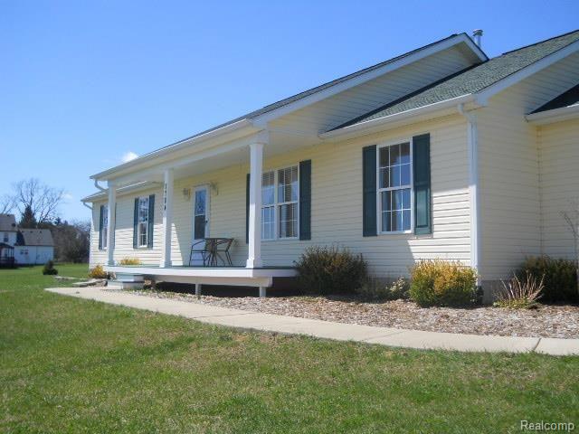 7784 West Lange Road Fowlerville, MI 48836 - Photo 4 of 28 sidewalk to porch