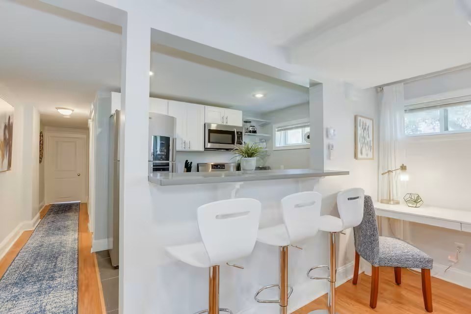 134 Newbury Avenue, Unit 1A Quincy, MA 02171 - Photo 2 of 13 a kitchen with stainless steel appliances granite countertop a dining table chairs and a refrigerator
