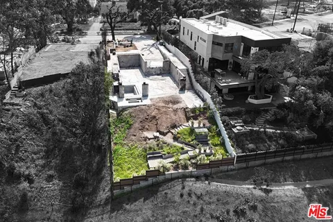 a buildings covered with tall trees