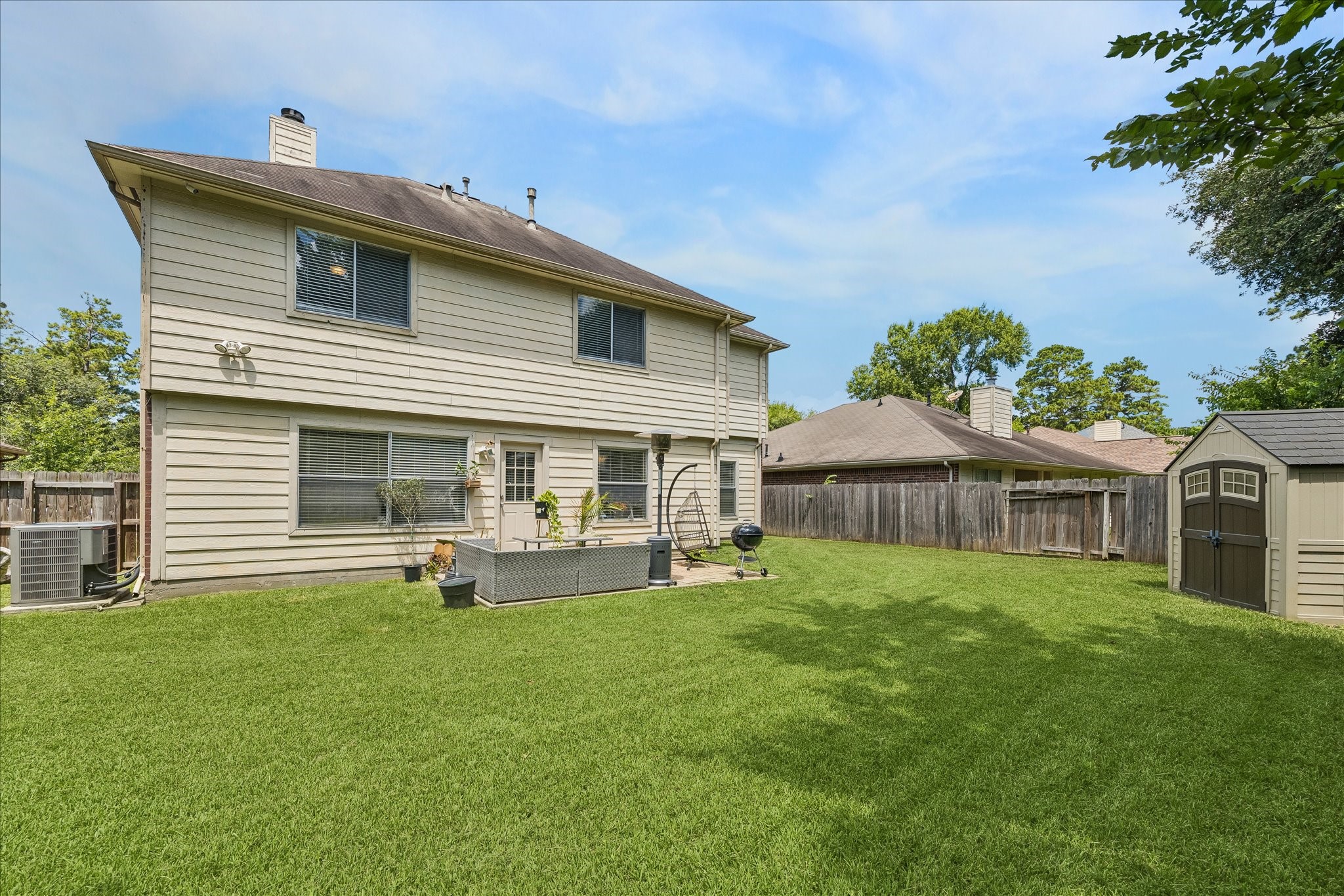 23234 Grand Rapids Lane Spring, TX 77373 - Photo 28 of 30 Charming two-story home backs to a generously sized, fully fenced yard with a cozy patio area — perfect for outdoor gatherings.