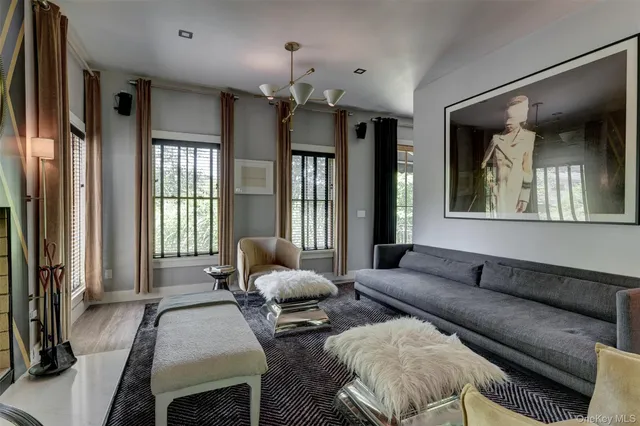 a living room with furniture and a chandelier