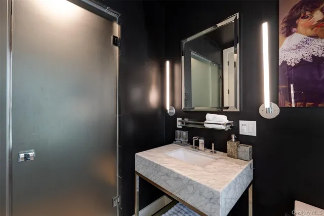 a bathroom with a sink a toilet and mirror