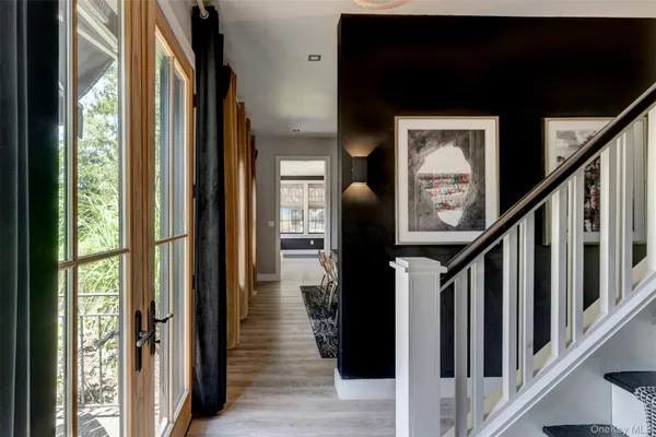 a view of hallway with wooden floor and stairs