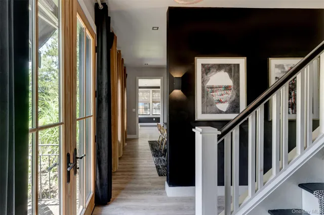 a view of hallway with wooden floor and stairs