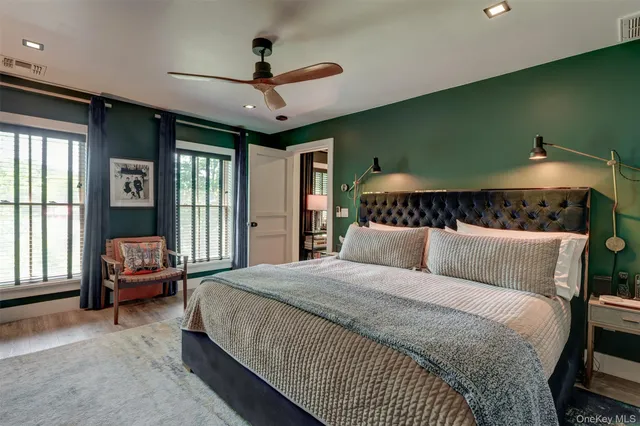 a bedroom with a large bed and a large window