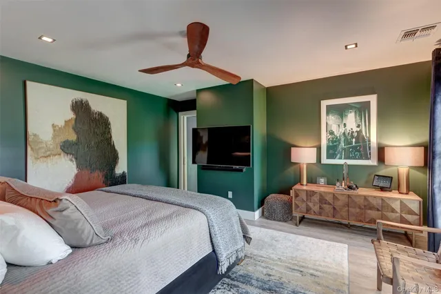 a bedroom with a bed and a mirror