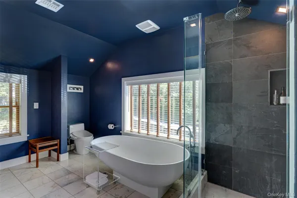 a spacious bathroom with a bathtub and shower