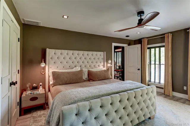 a bedroom with a large bed and a chandelier
