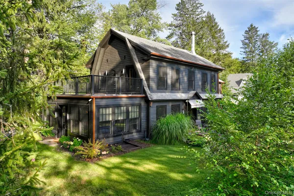 a front view of a house with yard and green space