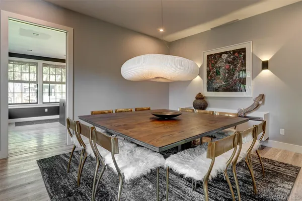a view of a dining room with furniture and wooden floor