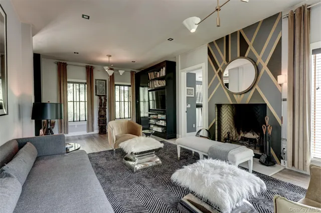 a living room with furniture a rug and white walls