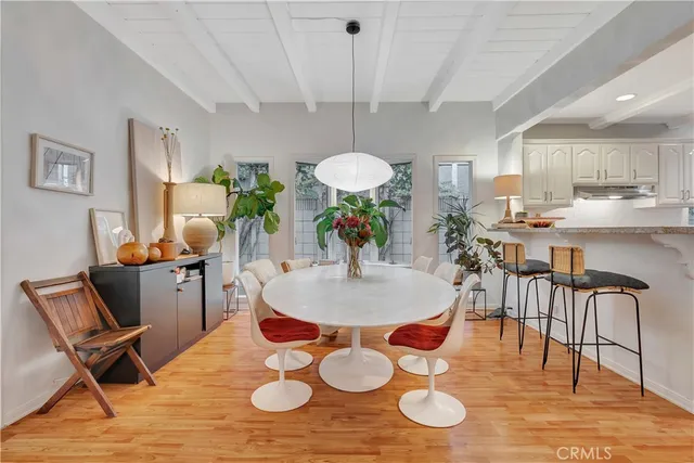 a view of dining room and kitchen with table and chairs
