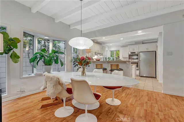 a living room with furniture kitchen view and a chandelier