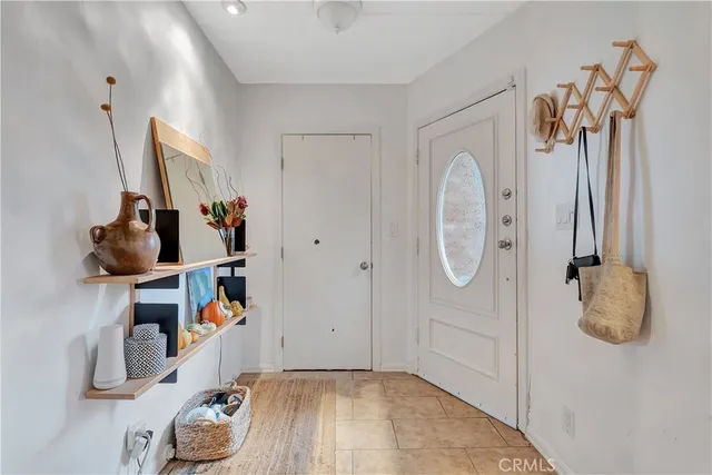 a living room with furniture a table and a large window