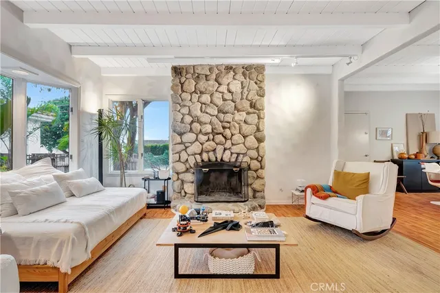 a living room with furniture a fireplace and a table