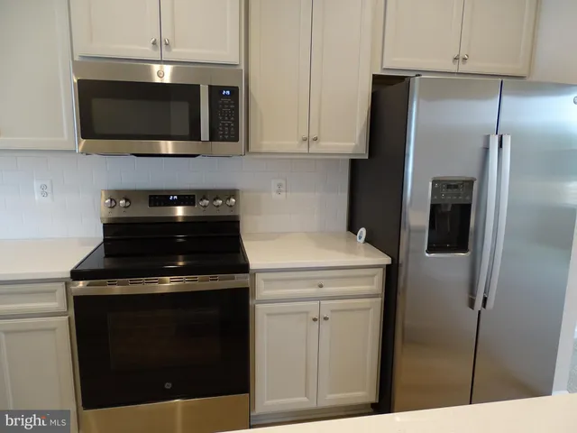 a kitchen with a stove and a microwave