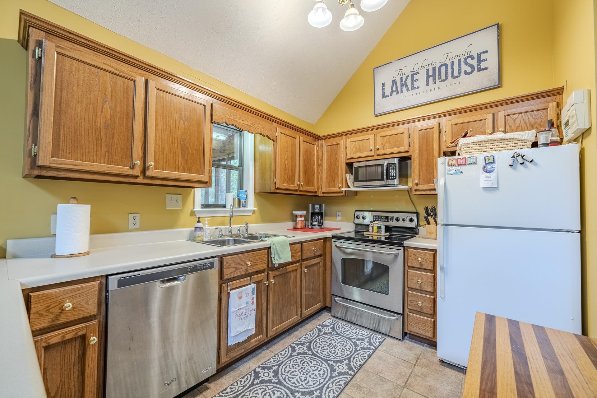 405 Murray Lane Counce, TN 38326 - Photo 16 of 36 a kitchen with stainless steel appliances granite countertop a refrigerator a stove a sink dishwasher and a microwave