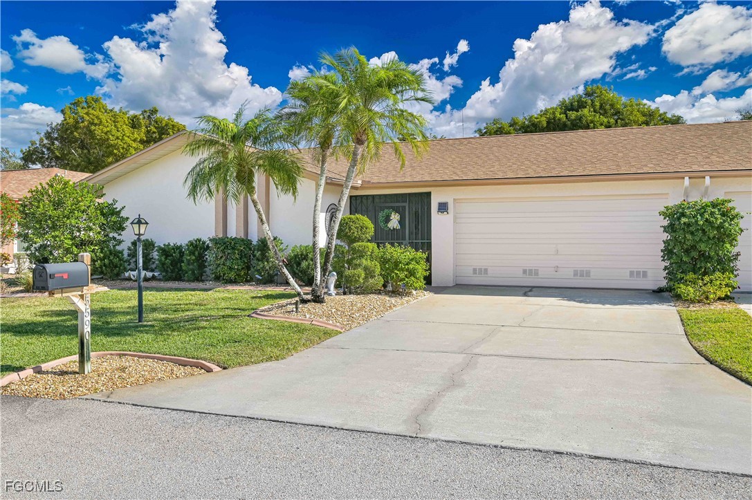 5590 Buring Court Fort Myers, FL 33919 - Photo 2 of 38 a palm tree sitting in front of a house with a big yard