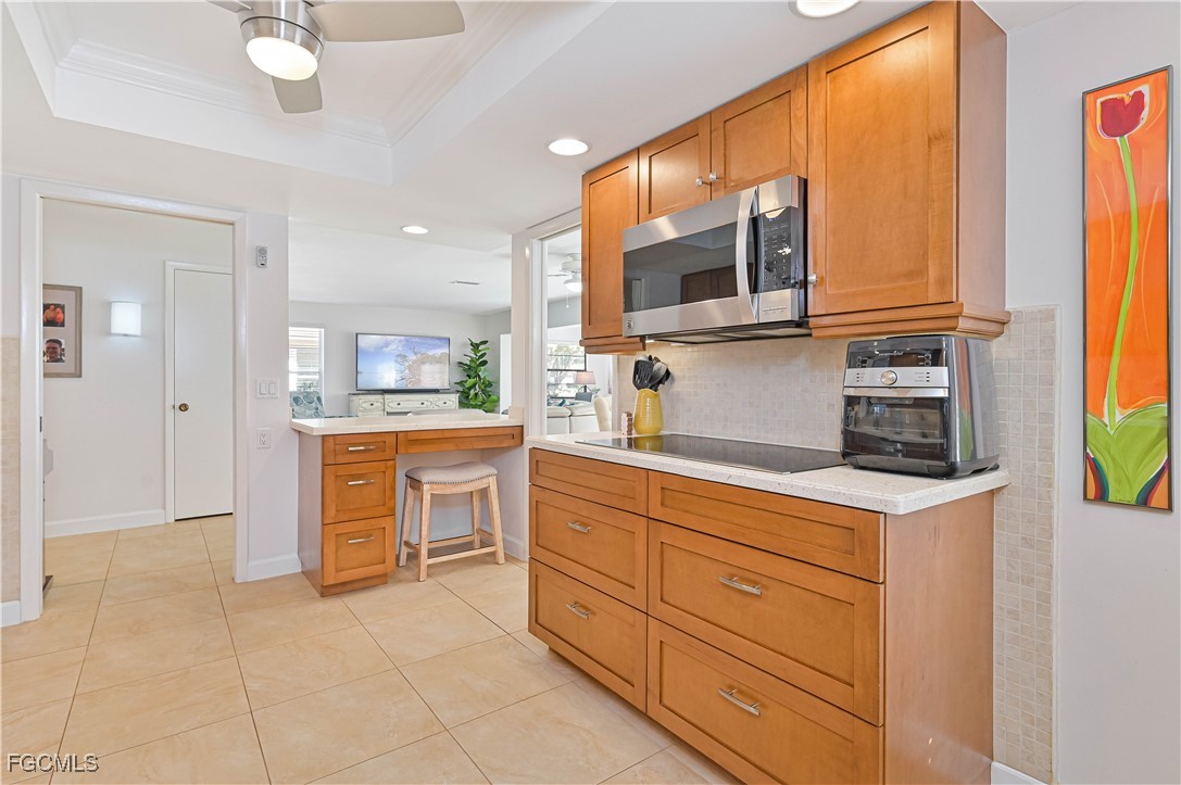 5590 Buring Court Fort Myers, FL 33919 - Photo 23 of 38 a kitchen with a refrigerator and microwave